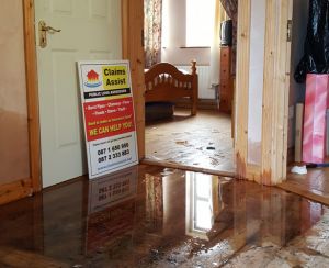 Water damage on wooden floor assessed by Claims Assist - insurance advice when needed.
